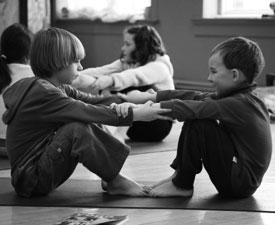 two elementary school boys enjoying a yoga class