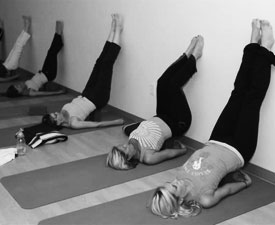 Yoga class with women doing restorative pose